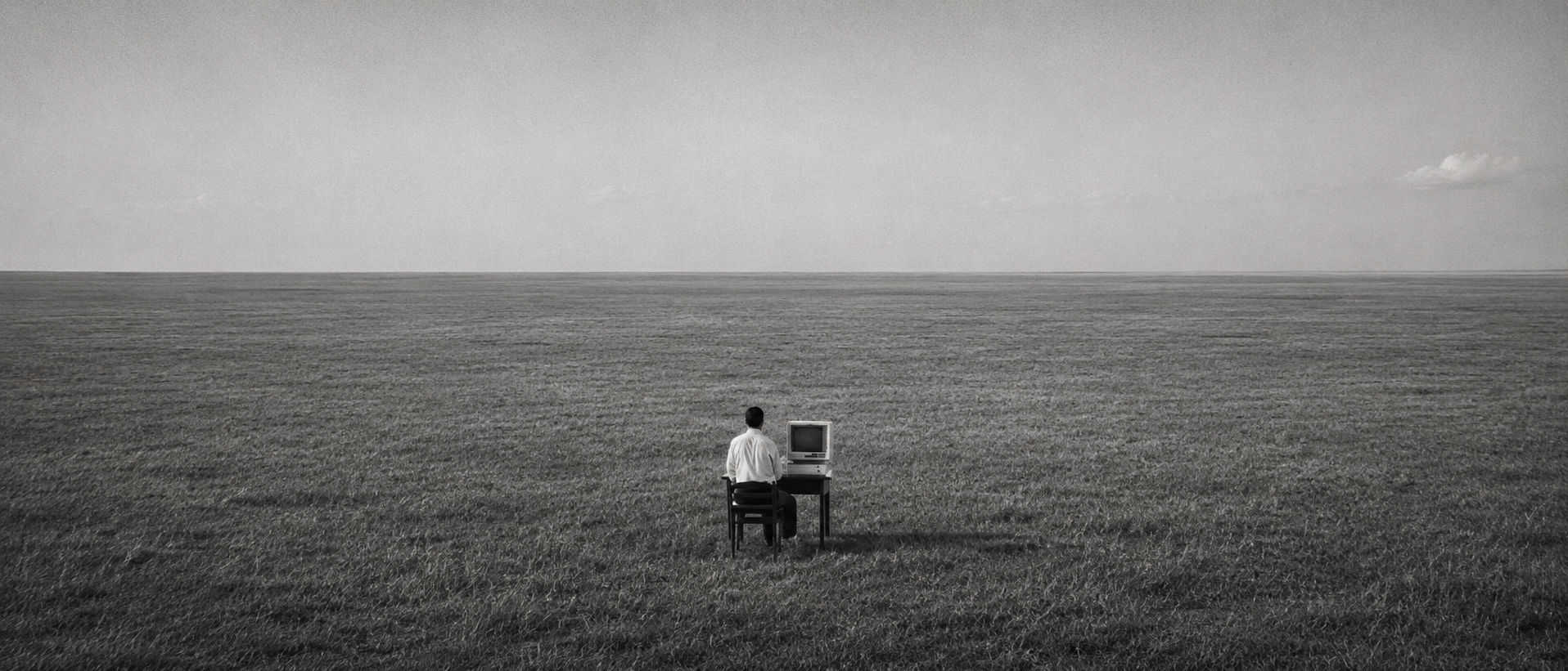 A person working at a computer in an open field